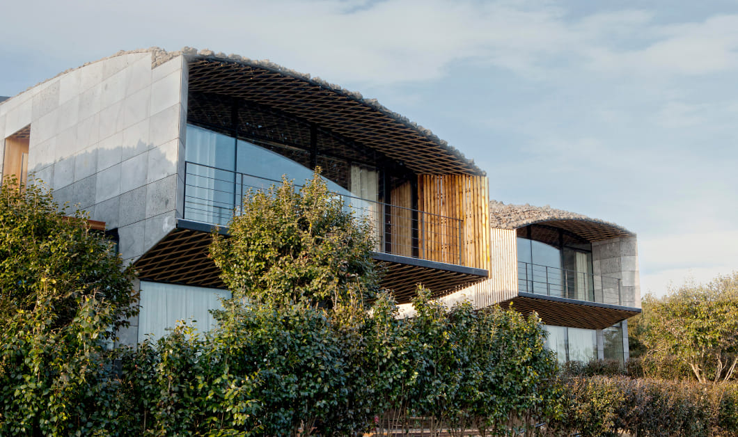   Lotte Jeju Art Villas Kengo Kuma - Rooms designed to embody the rounded shapes of Jeju's oreums, allowing you to experience the strength and flexibility of Jeju's nature.